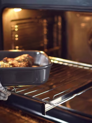 man-takes-baking-sheet-with-meat-out-ovencook-home_801579-478